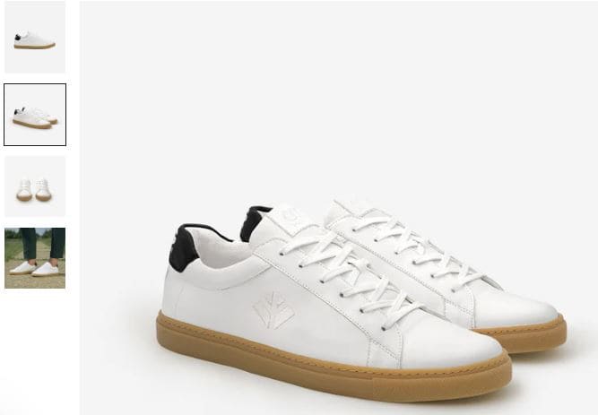 A pair of Winton Vegan Sneakers by COG, featuring white uppers and contrasting black soles, displayed on a neutral background.