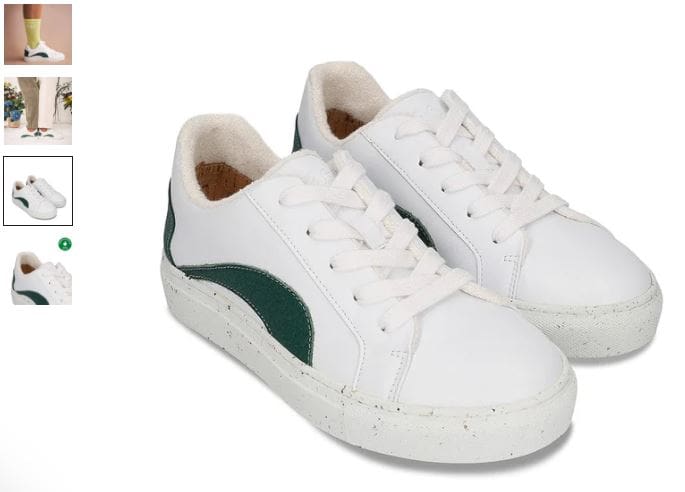 A pair of white sneakers featuring green trim, made from Piñatex and apple leather, designed for unisex wear by NAE. 