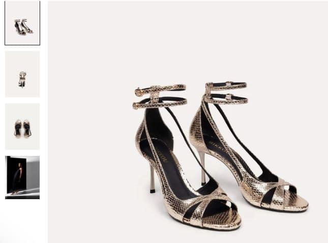 A pair of gold strappy high heels featuring a stylish snake skin pattern, perfect for a night out with friends.