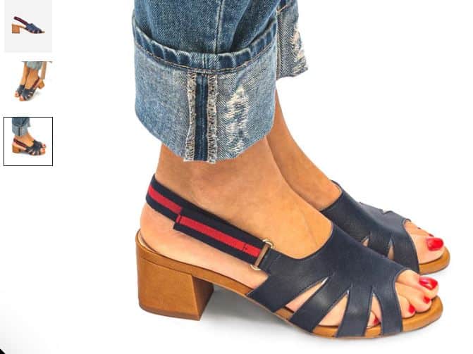 A close-up of a woman's feet wearing Silvia Vegan Leather Heeled Sandals in blue with red and blue stripes.