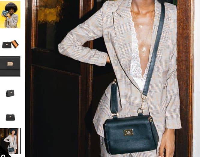 A woman in a suit holds a stylish Trudy crossbody bag, showcasing its versatility as a chic clutch.