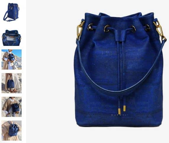 A navy blue leather bag featuring a gold chain, showcasing the Gamma Handcrafted Cork Vegan Bucket Backpack by Murmali.